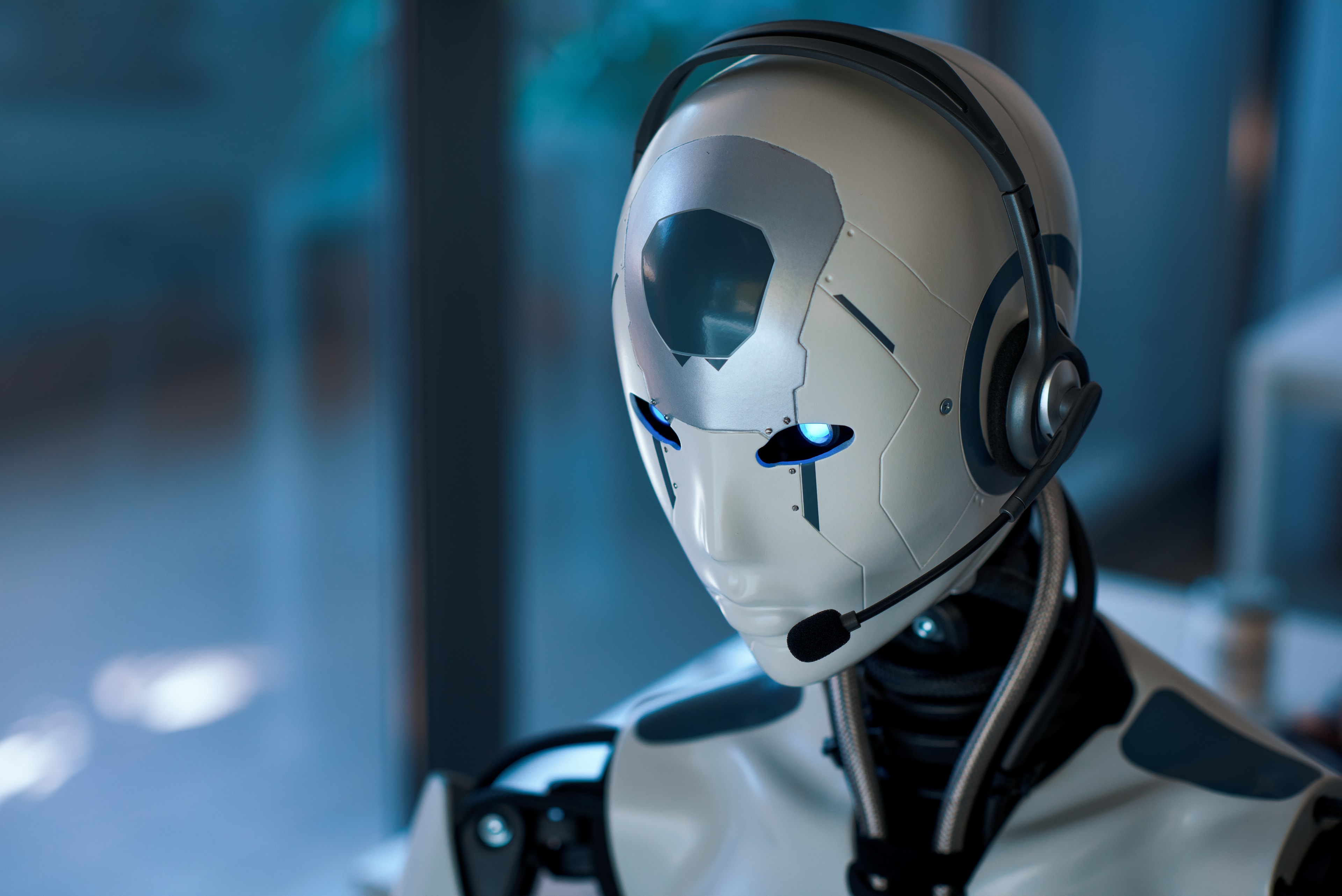 Futuristic robot with a headset in a tech workplace for the AI-ONO Tech project
